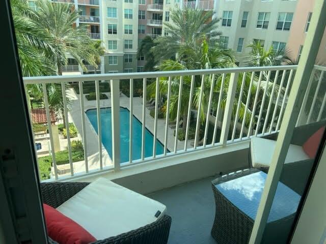 a view of a balcony with chair and wooden floor