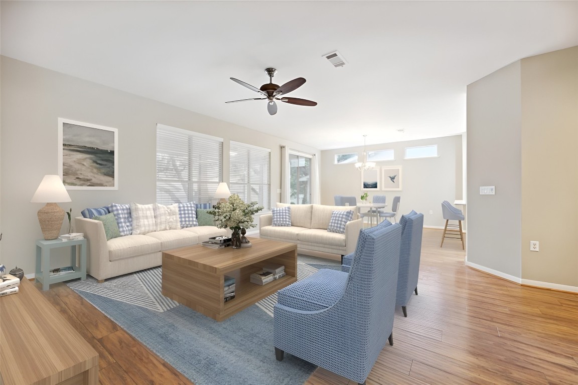 a living room with furniture and a wooden floor