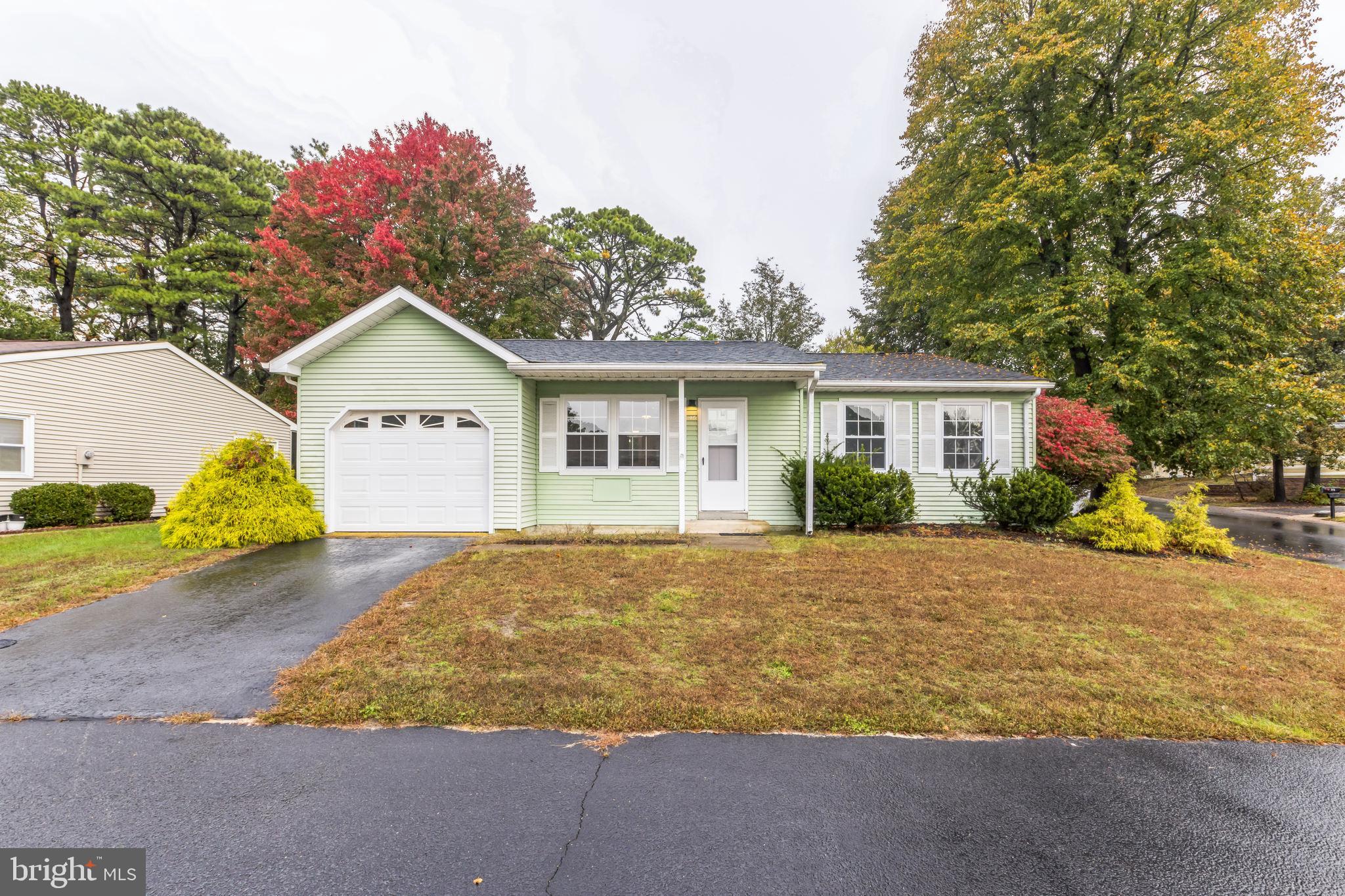 a view of a house with a yard and garage