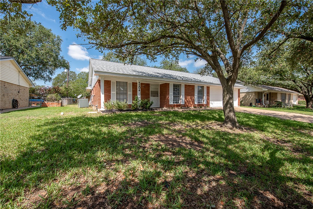 View of front of house featuring central AC, a fro