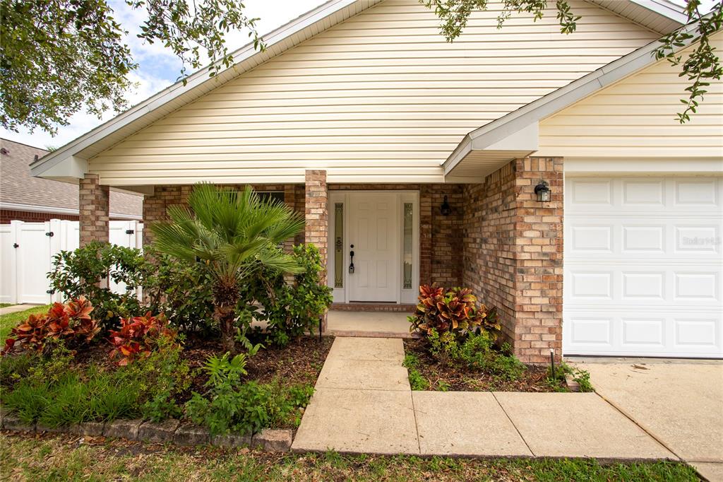 a view of a house with potted plants