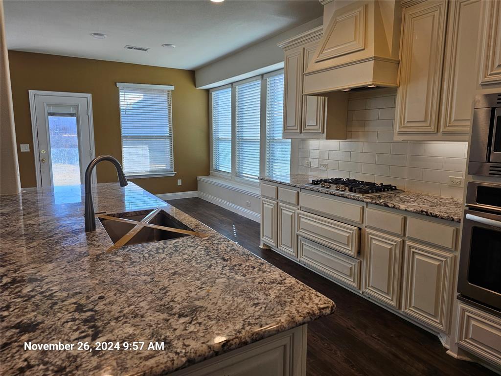 a kitchen with sink and cabinets