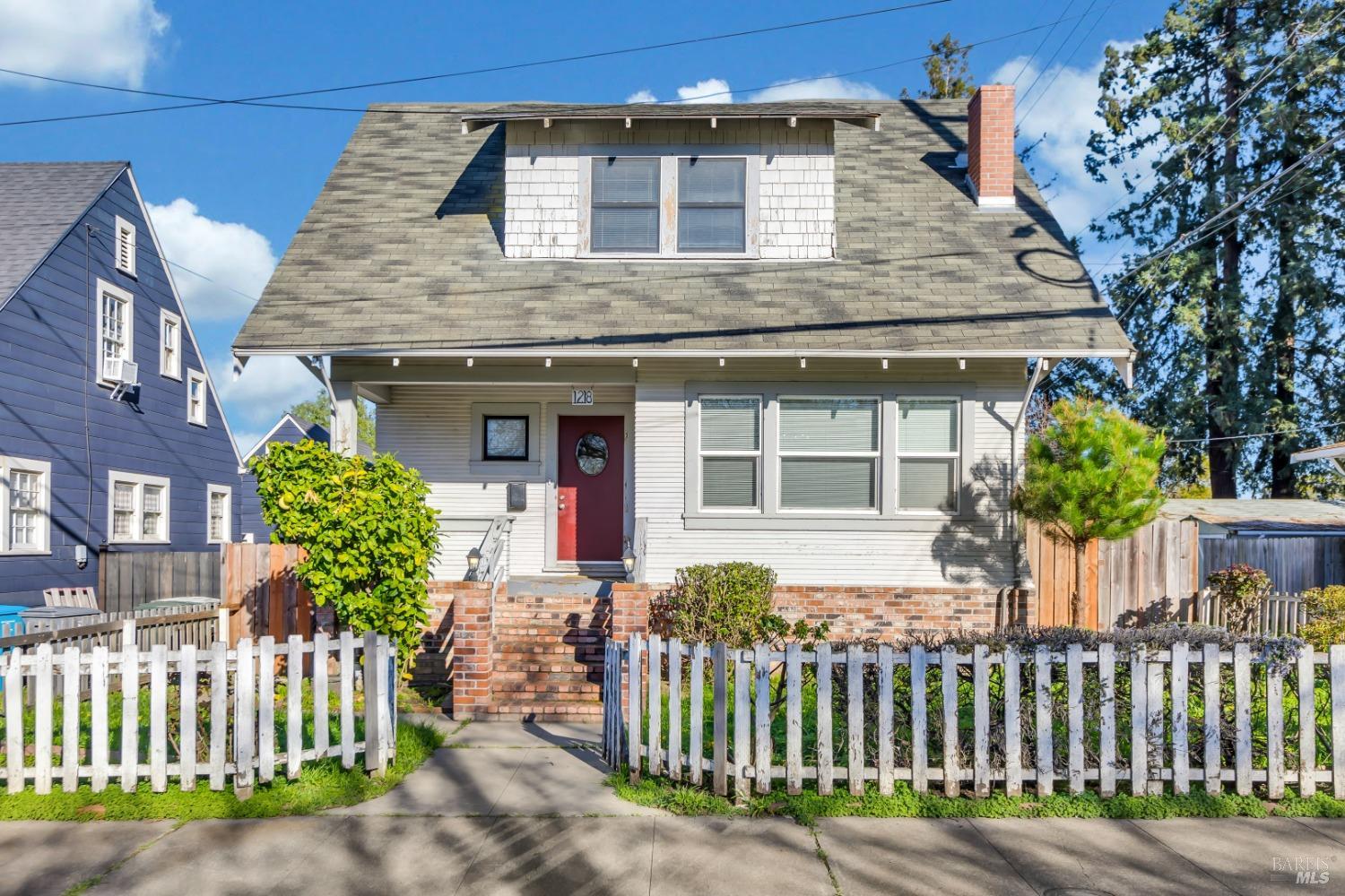 a front view of a house with a garden