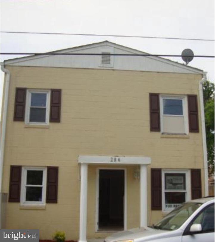 a front view of a house with parking space