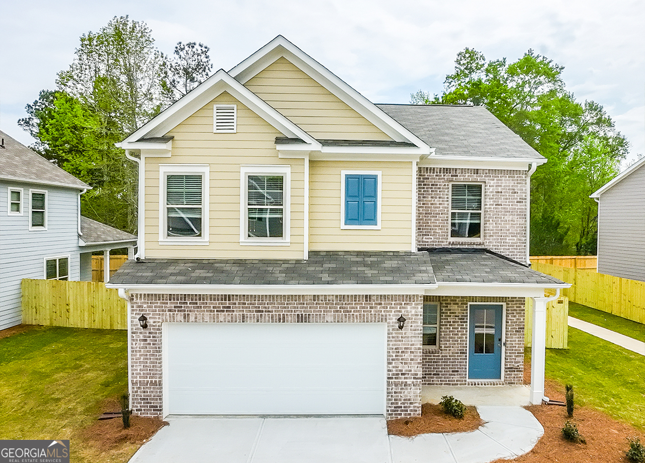 a front view of a house with a yard