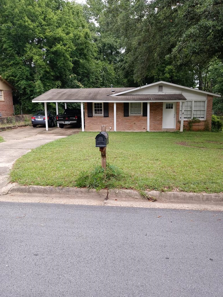 a front view of a house with a garden