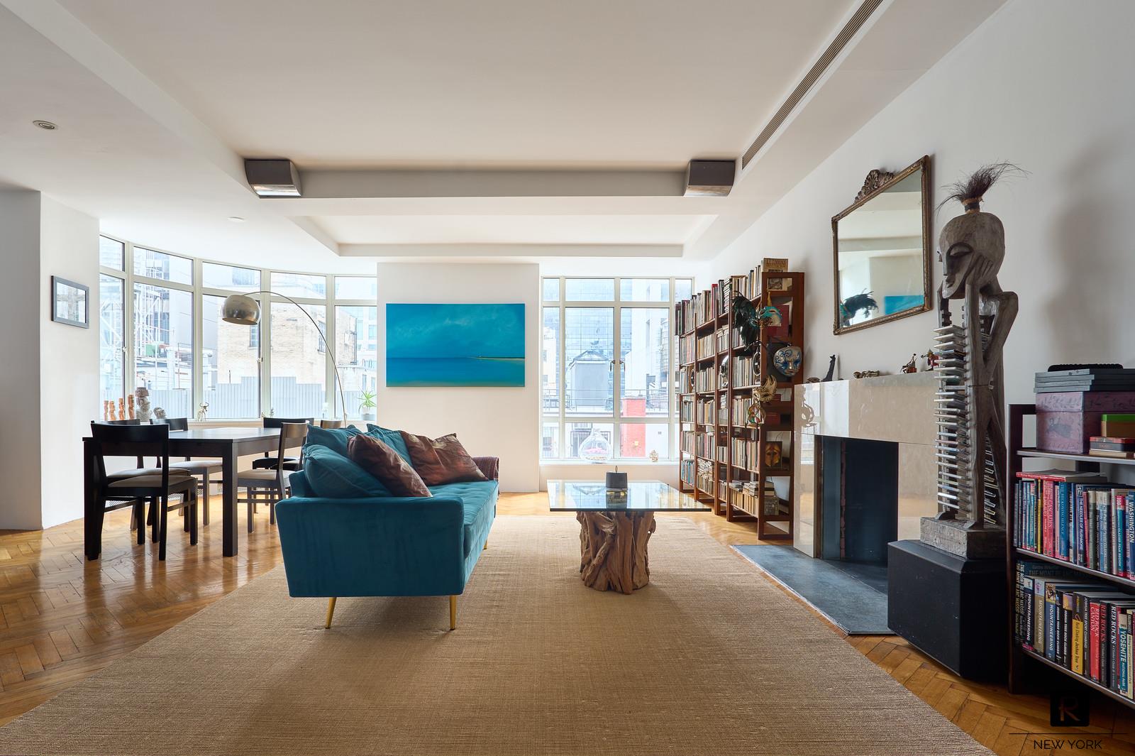 a living room with fireplace furniture and a book shelf