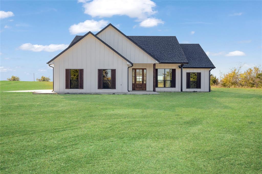 a front view of house with yard and green space