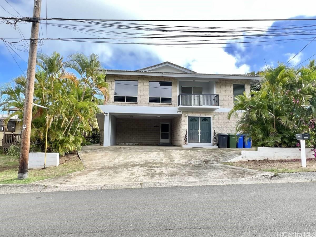 a view of a building with a window and palm tree