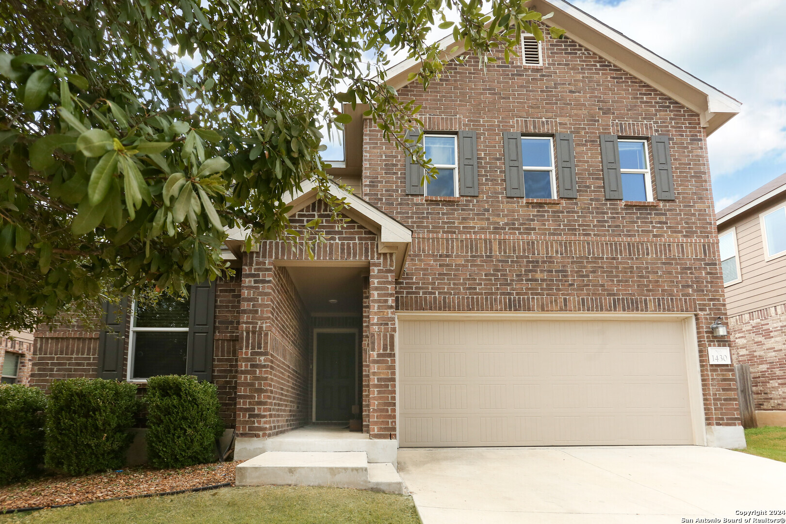 a front view of a house with yard