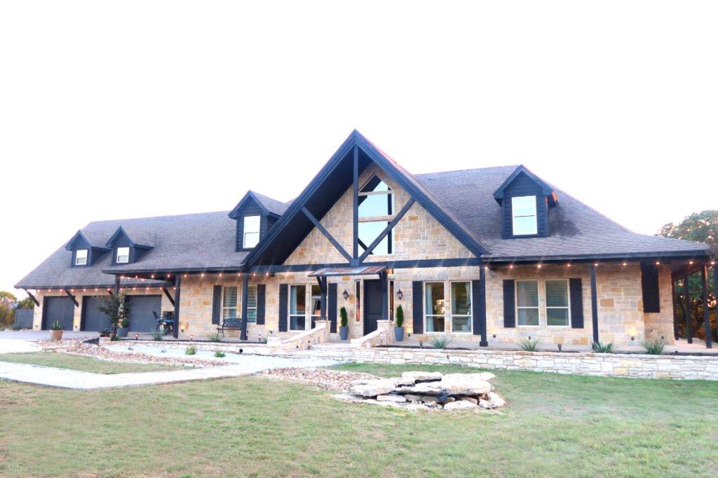 a front view of a house with swimming pool having outdoor seating