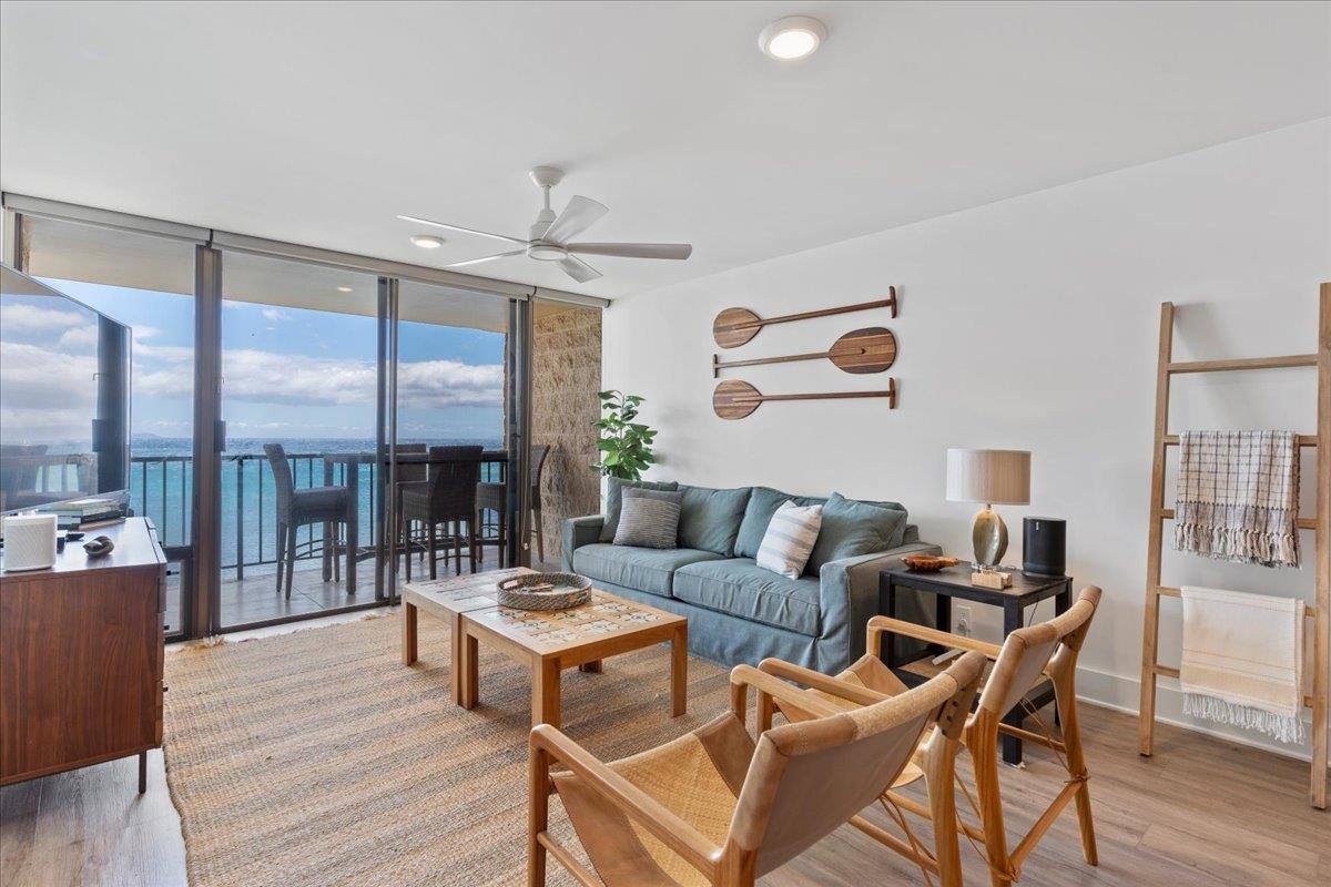 a living room with furniture and a floor to ceiling window