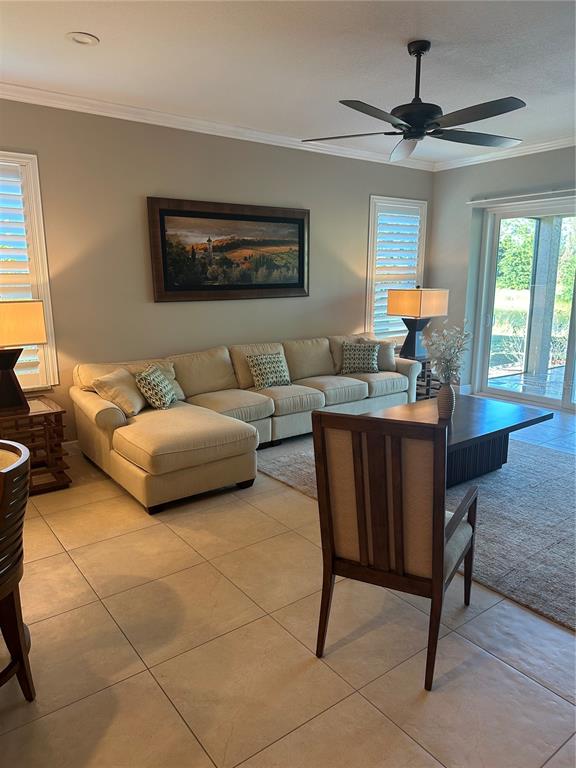 a living room with furniture a window and a flat screen tv