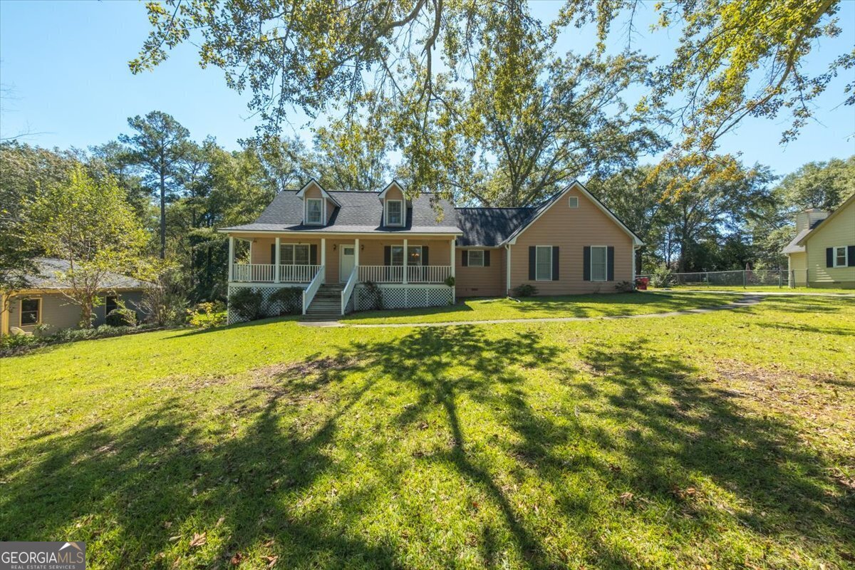 a front view of a house with swimming pool and porch