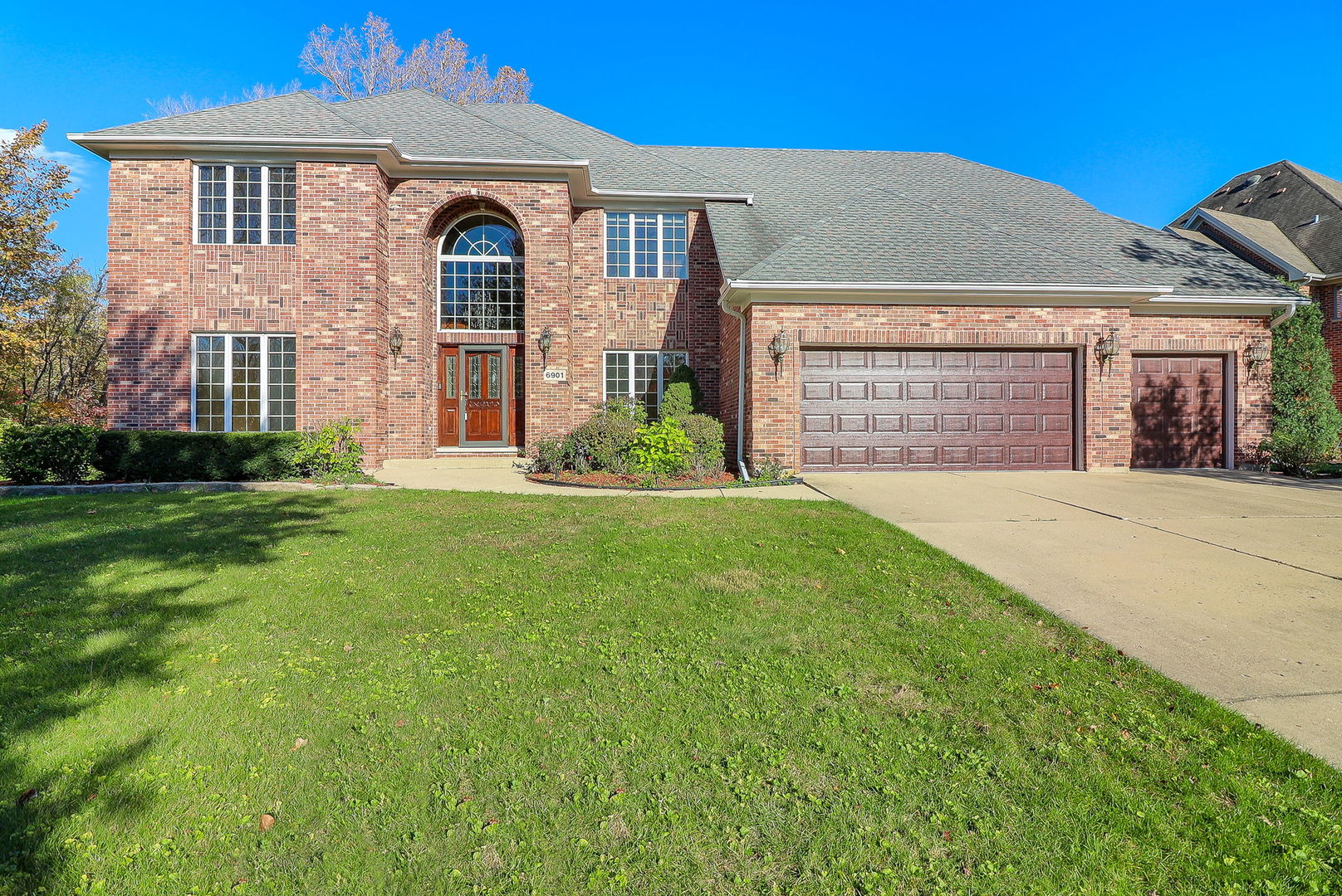 a front view of a house with a yard and garage