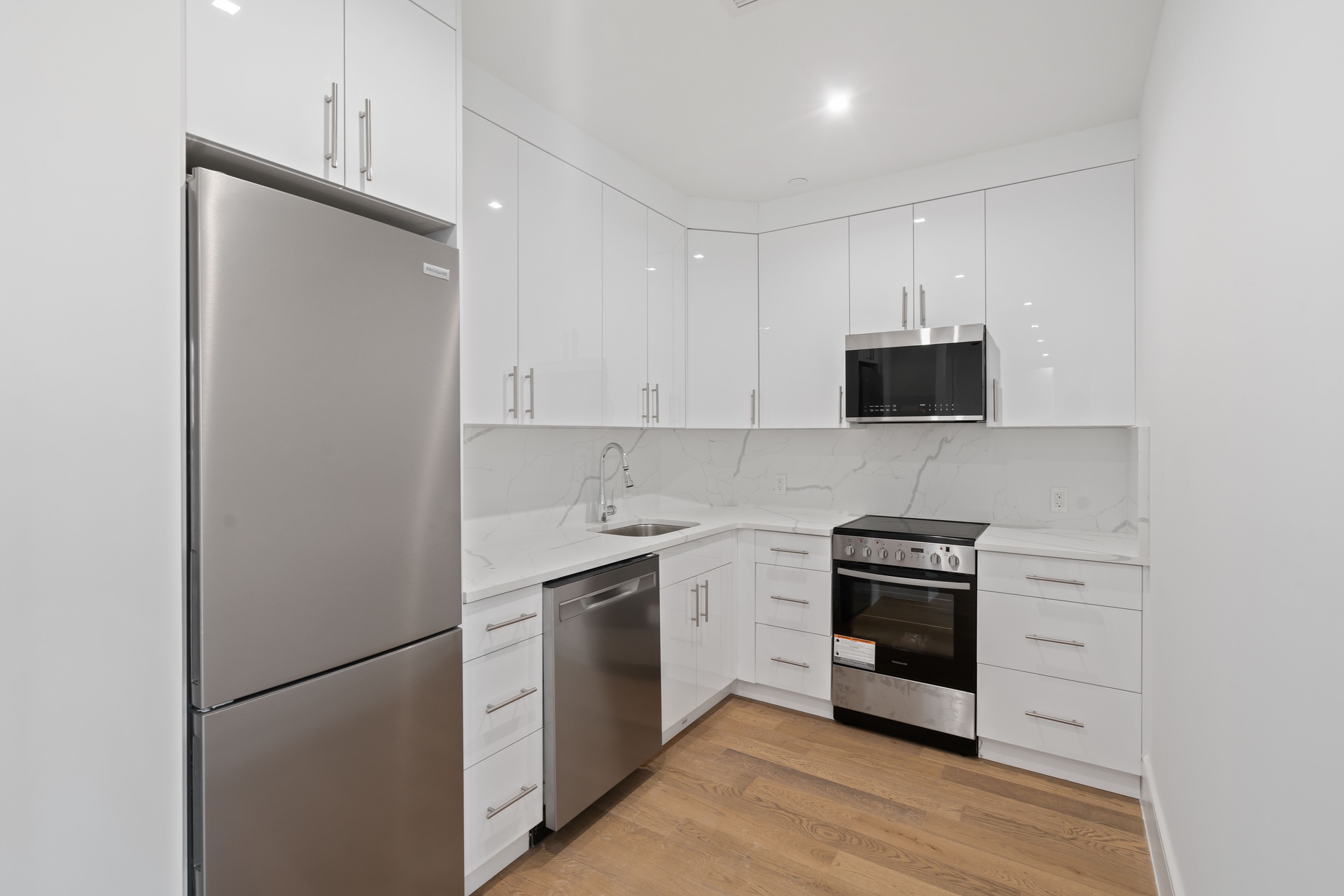 a kitchen with stainless steel appliances a refrigerator and a stove top oven