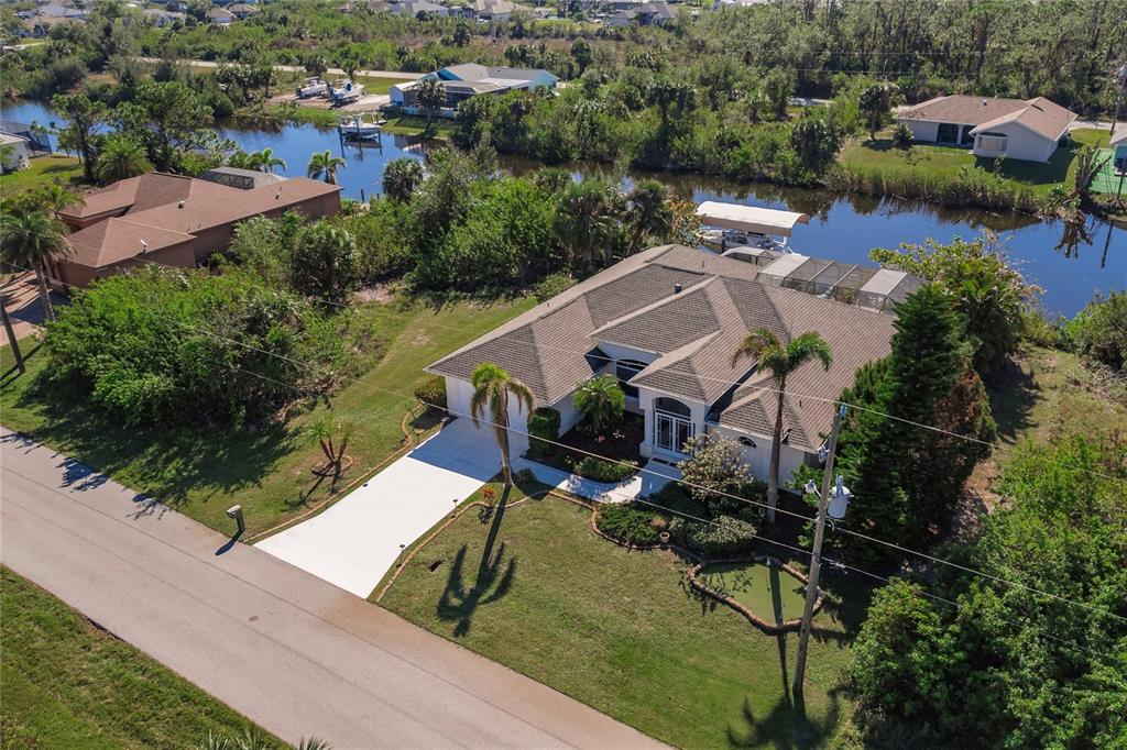 an aerial view of a house with outdoor space and lake view