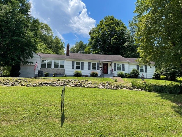 a front view of house with yard and swimming pool