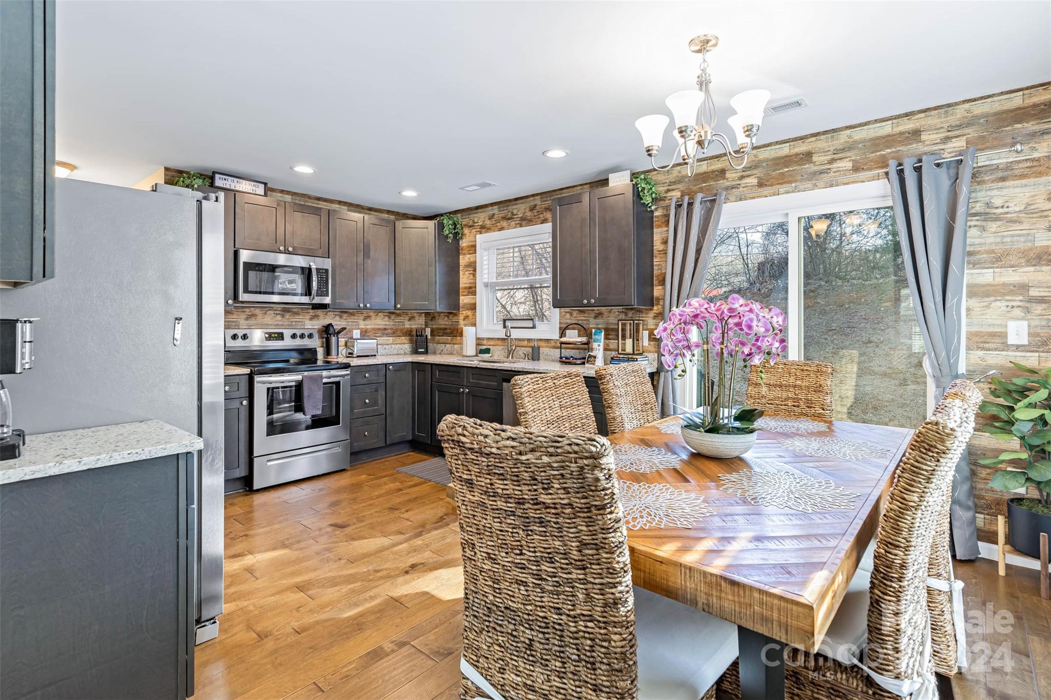 a kitchen with kitchen island a large counter top space appliances and cabinets