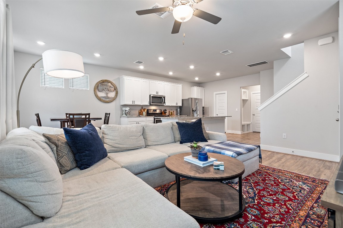 a living room with a couch and a clock