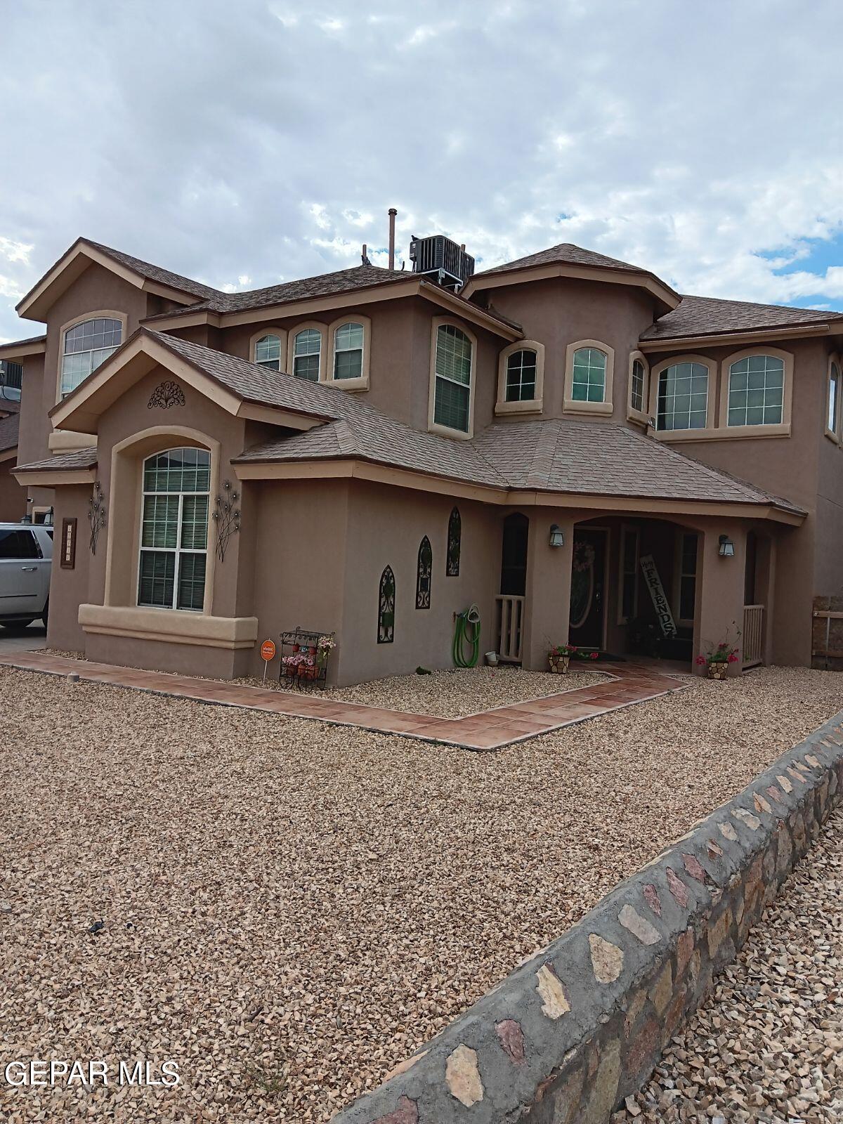 a front view of a house with a garden