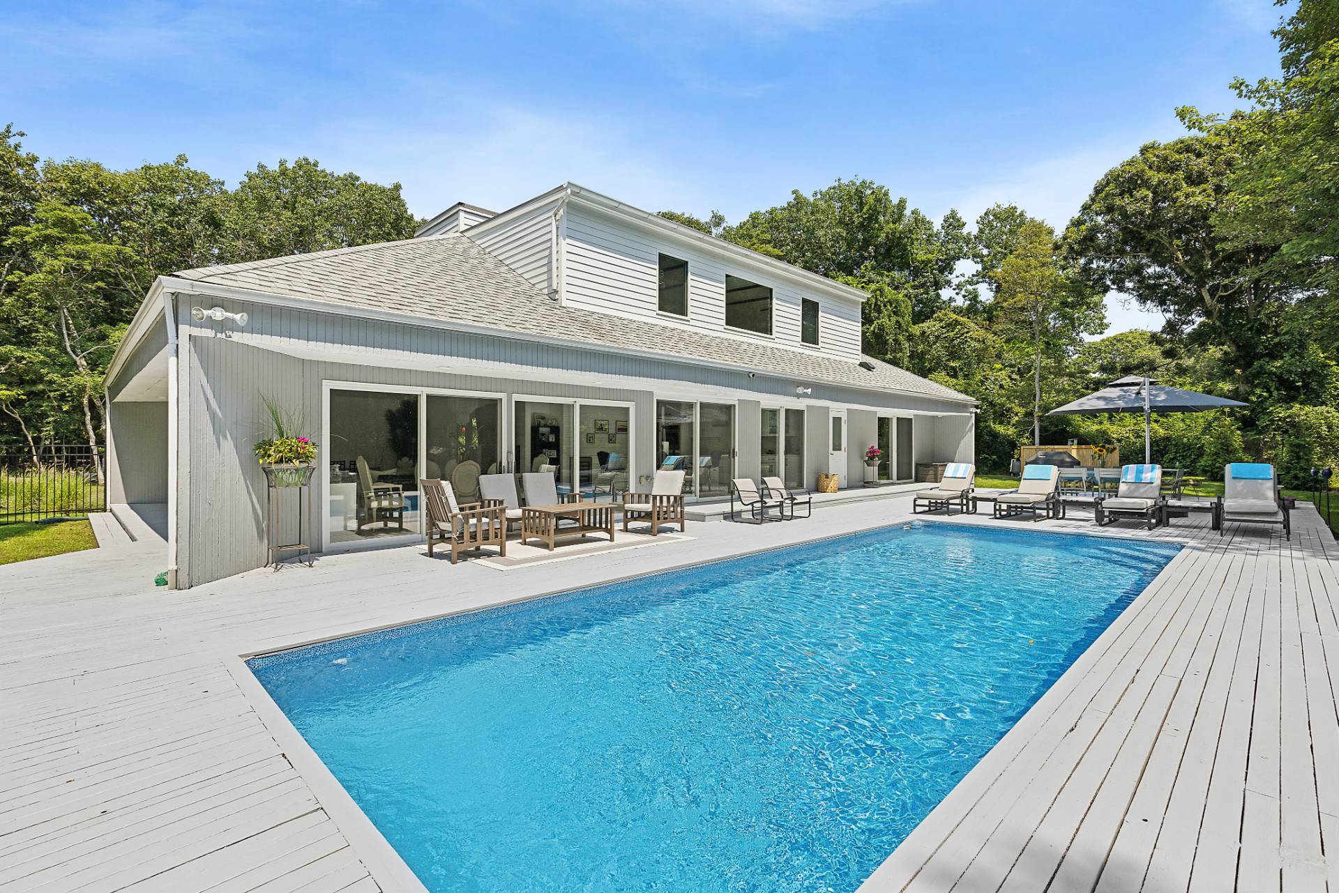 a front view of house with yard swimming pool and seating