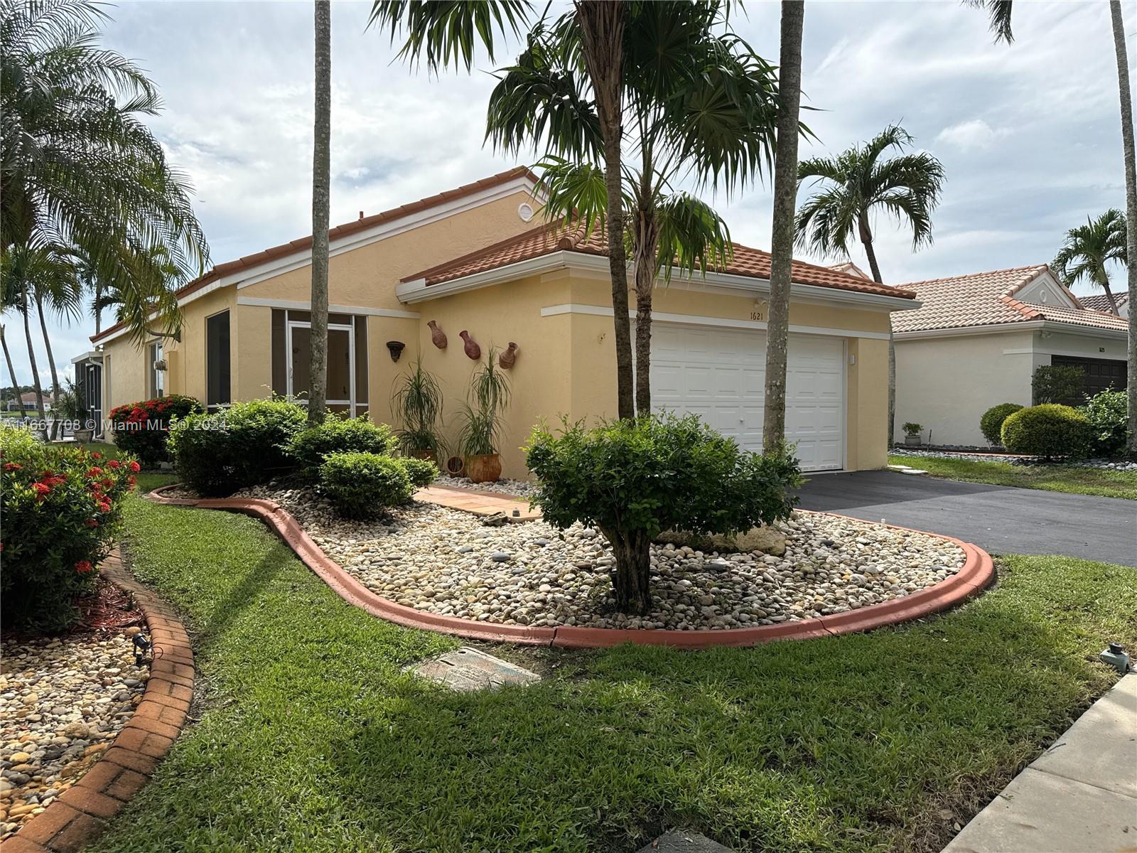 a view of a house with backyard and sitting area