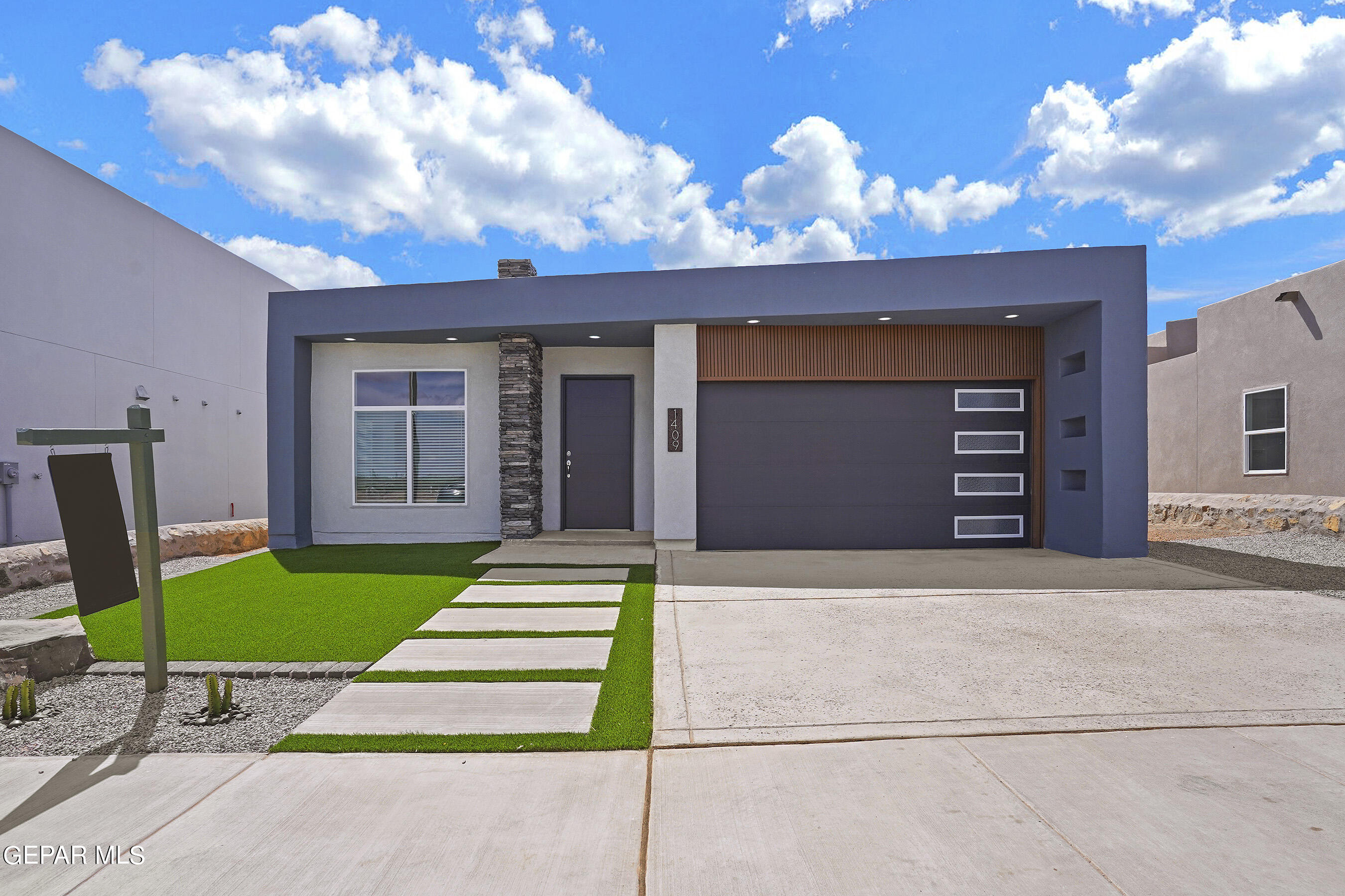 a front view of a house with a garden and yard