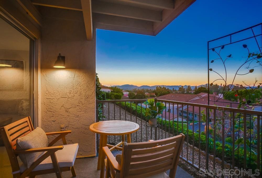 a view of a balcony with a table and chairs