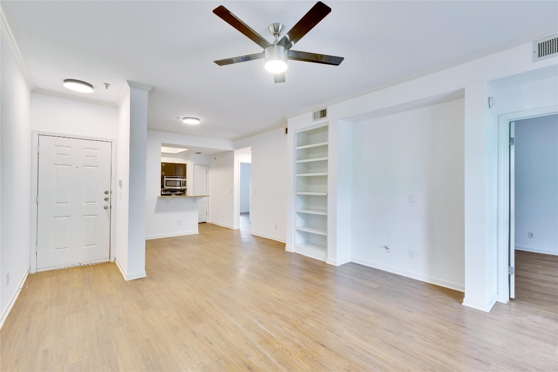 an empty room with closet and windows