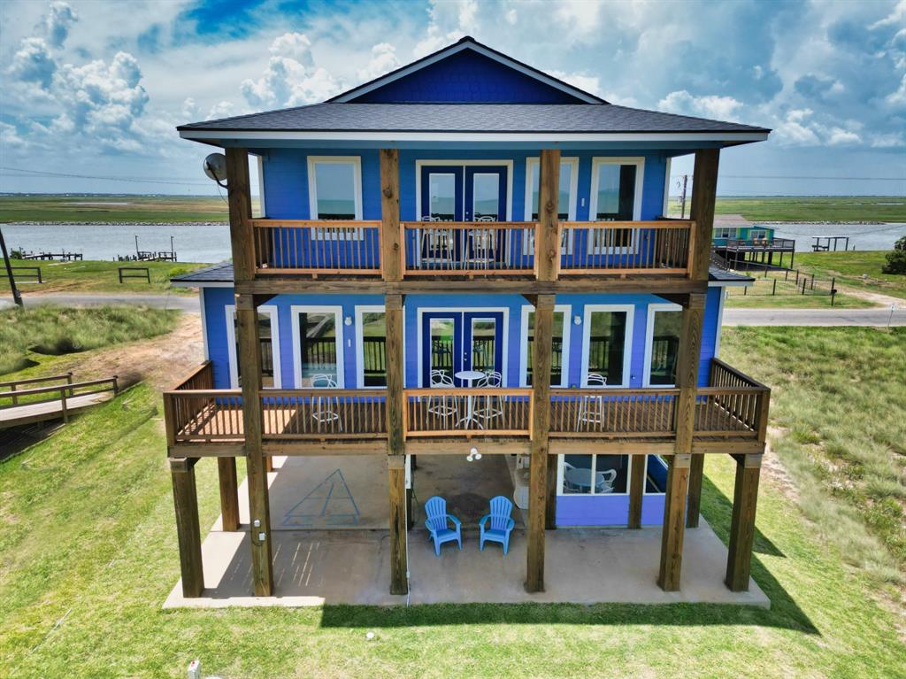 a view of a house with a yard balcony and a couches