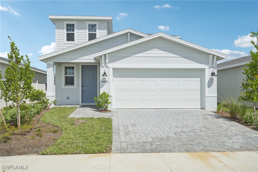 a front view of a house with a yard and garage