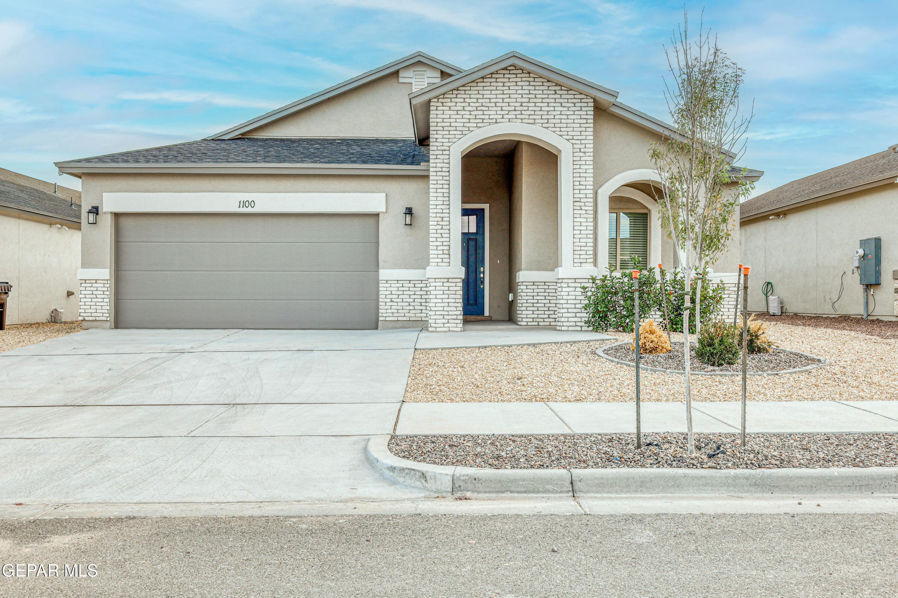 a front view of a house with garage