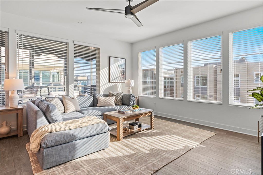 a living room with furniture and large windows