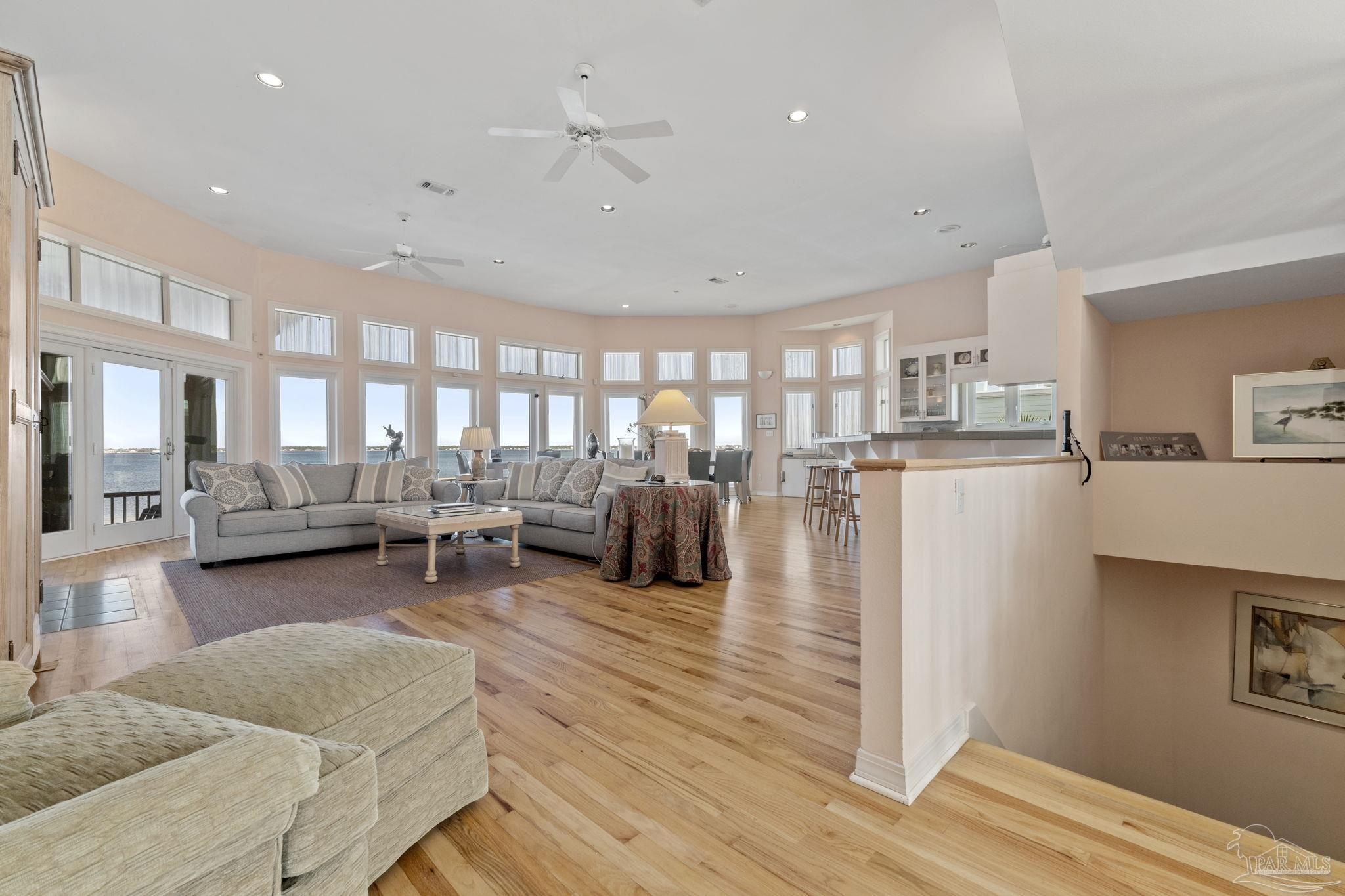 a living room with lots of furniture and a wooden floor