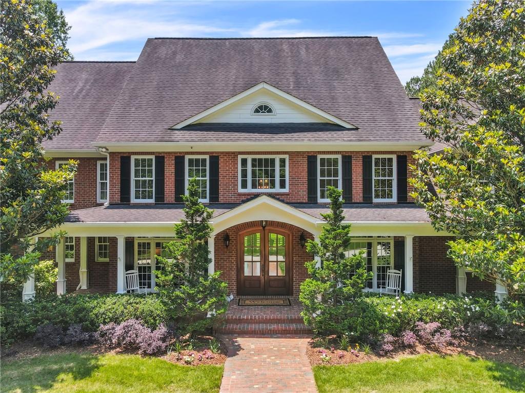 a front view of a house with a garden