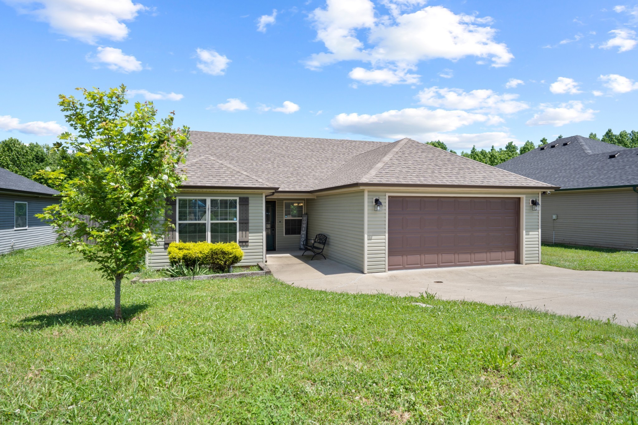 a front view of house with yard and green space