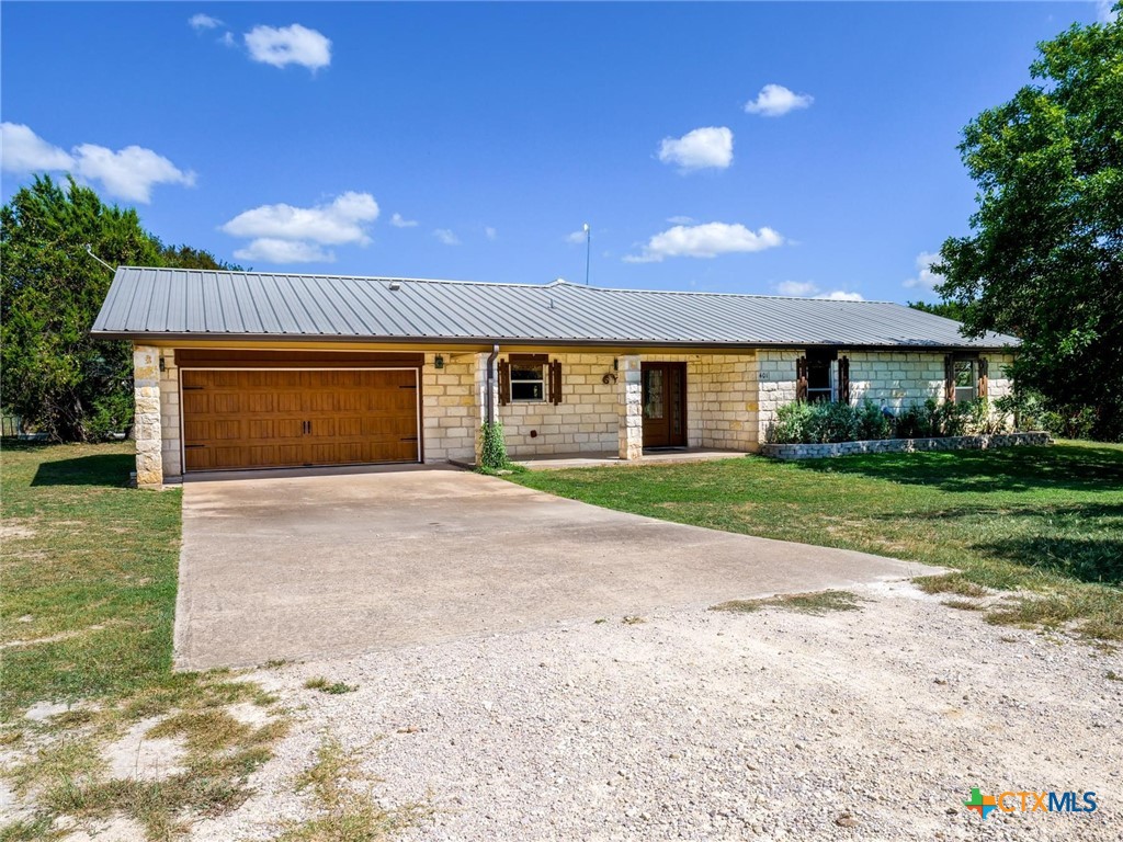 a view of house with yard and garage