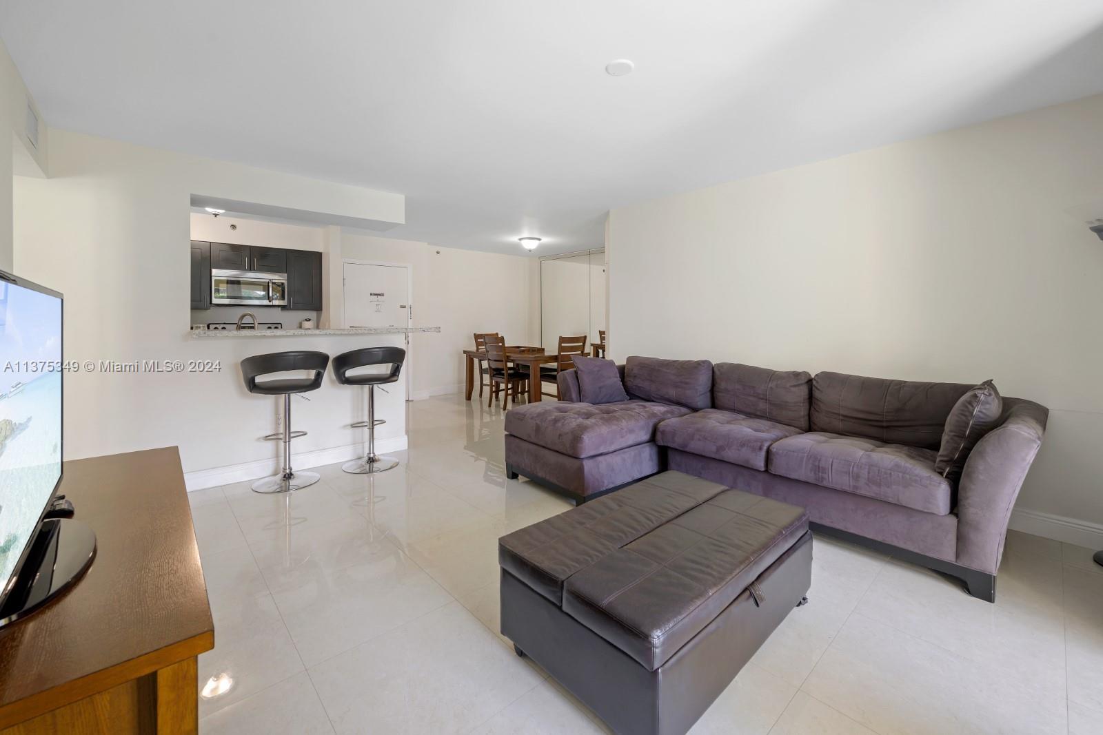 a living room with furniture and a lamp