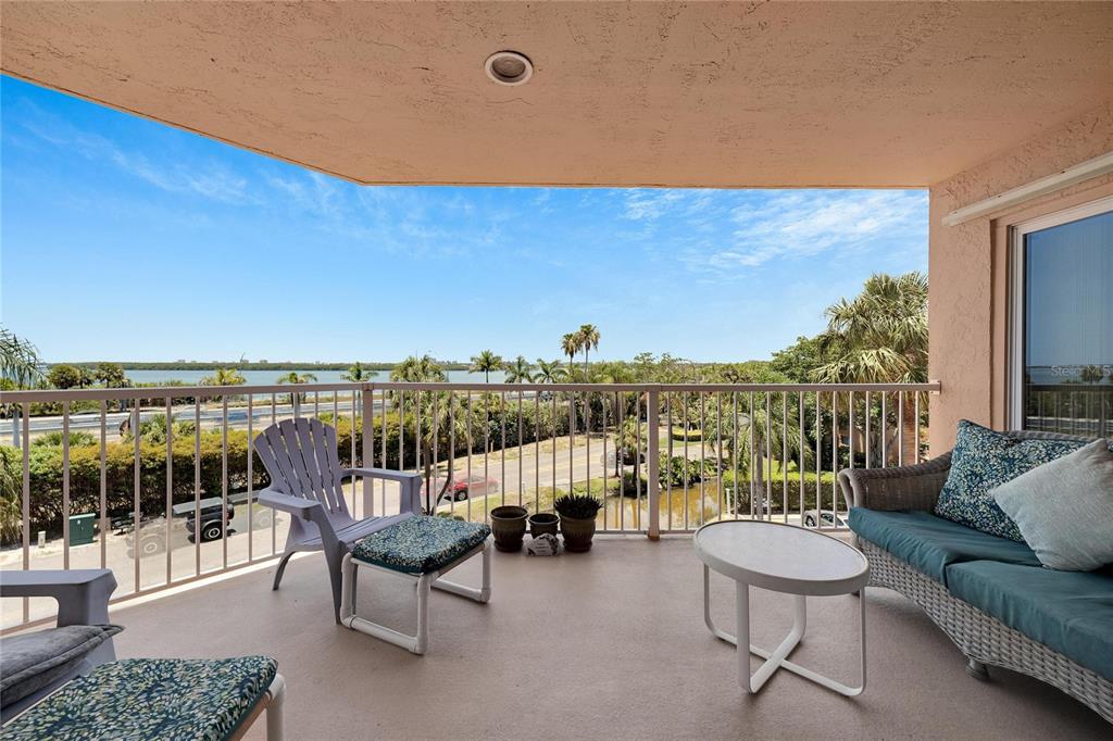 a balcony with furniture and city view