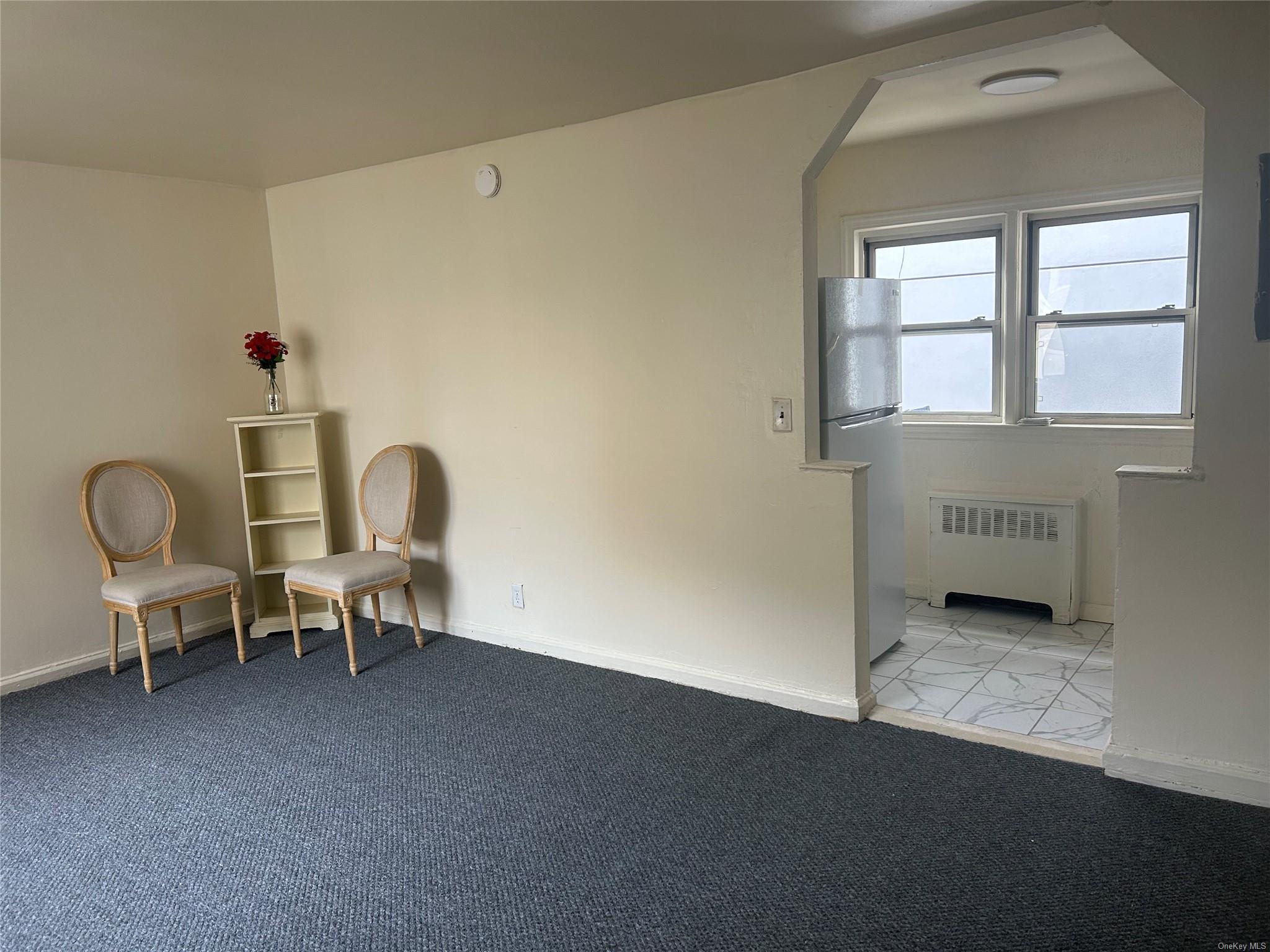 Unfurnished room with radiator