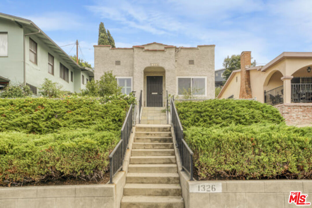 a view of a brick house with a yard