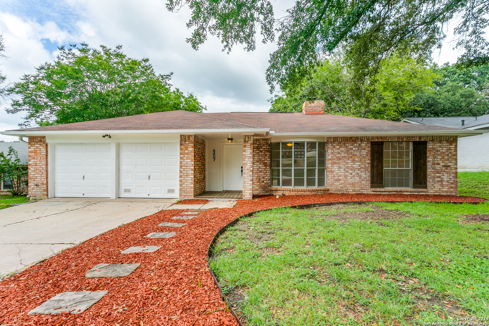 front view of a house with a yard