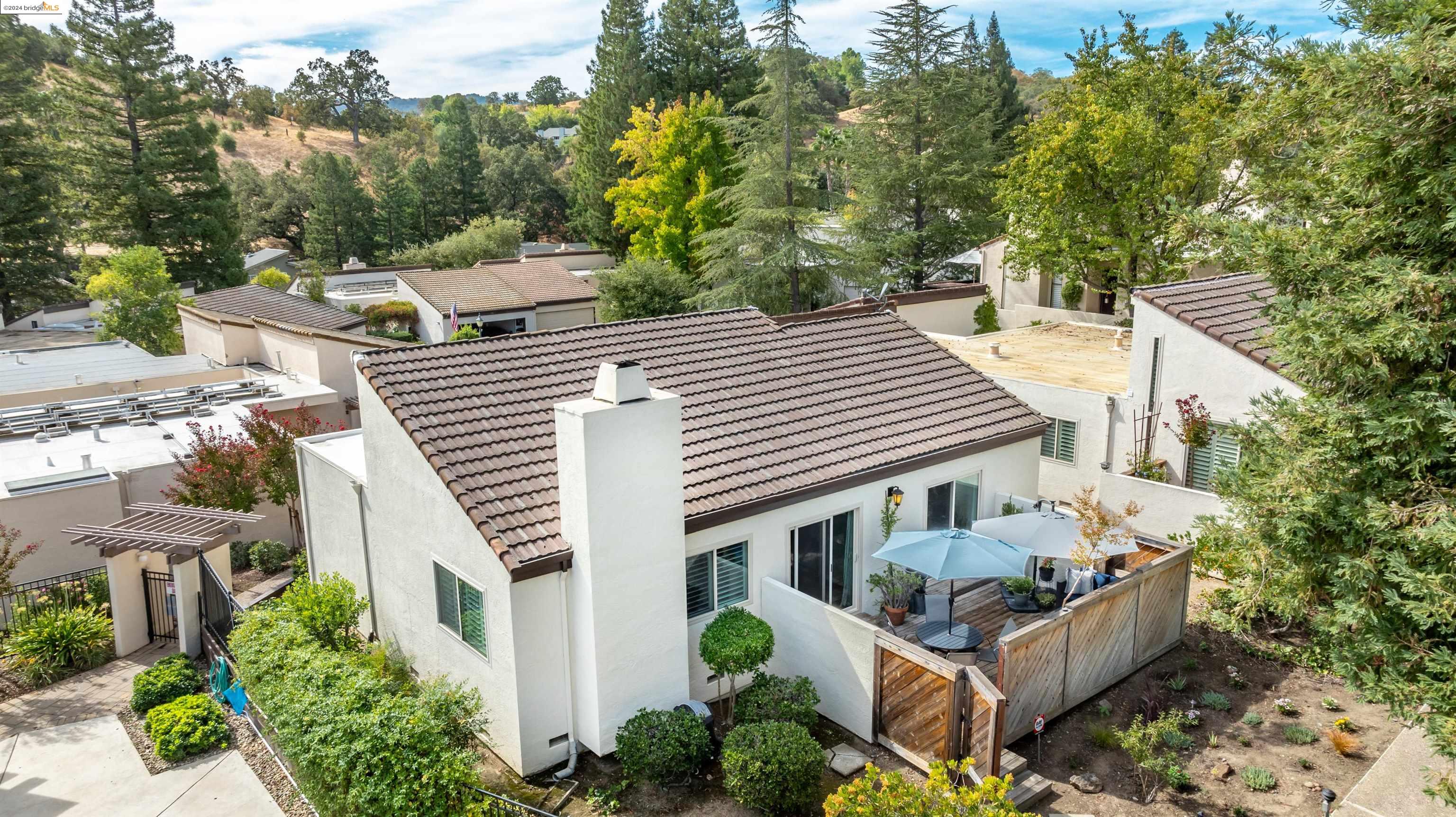 an aerial view of a house with porch and garden