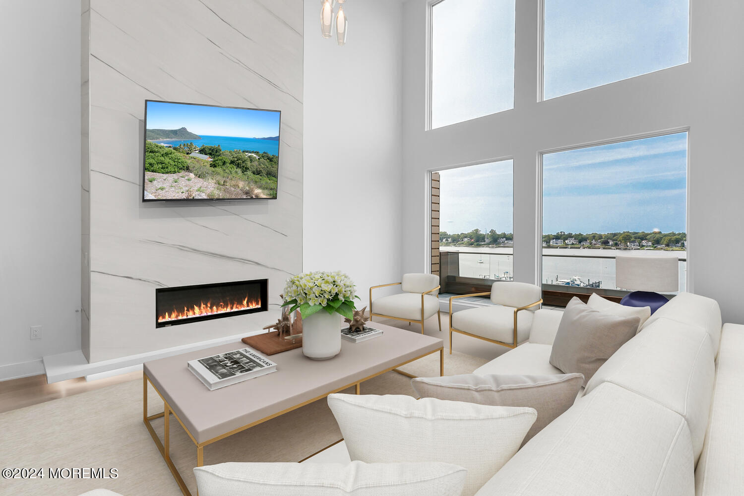 a living room with furniture a fireplace and a large window