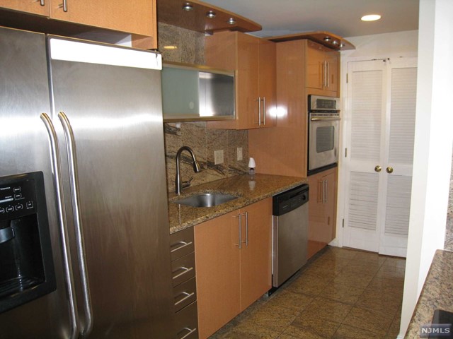 a kitchen with stainless steel appliances a refrigerator and a sink