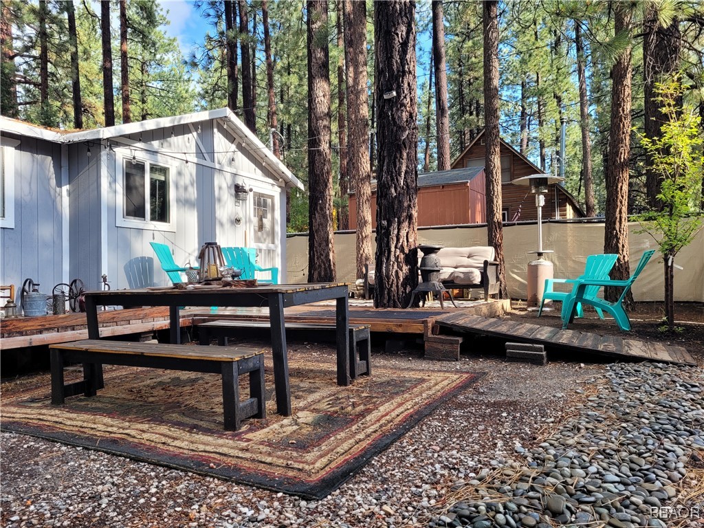 a view of a house with backyard and sitting area