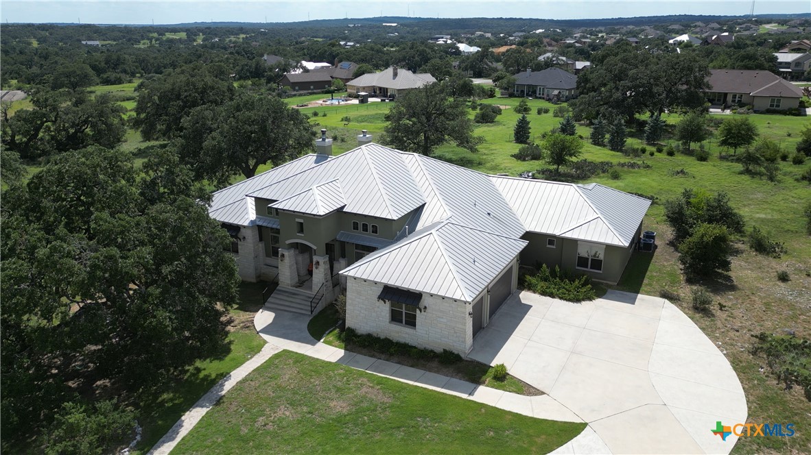 an aerial view of a house with a yard