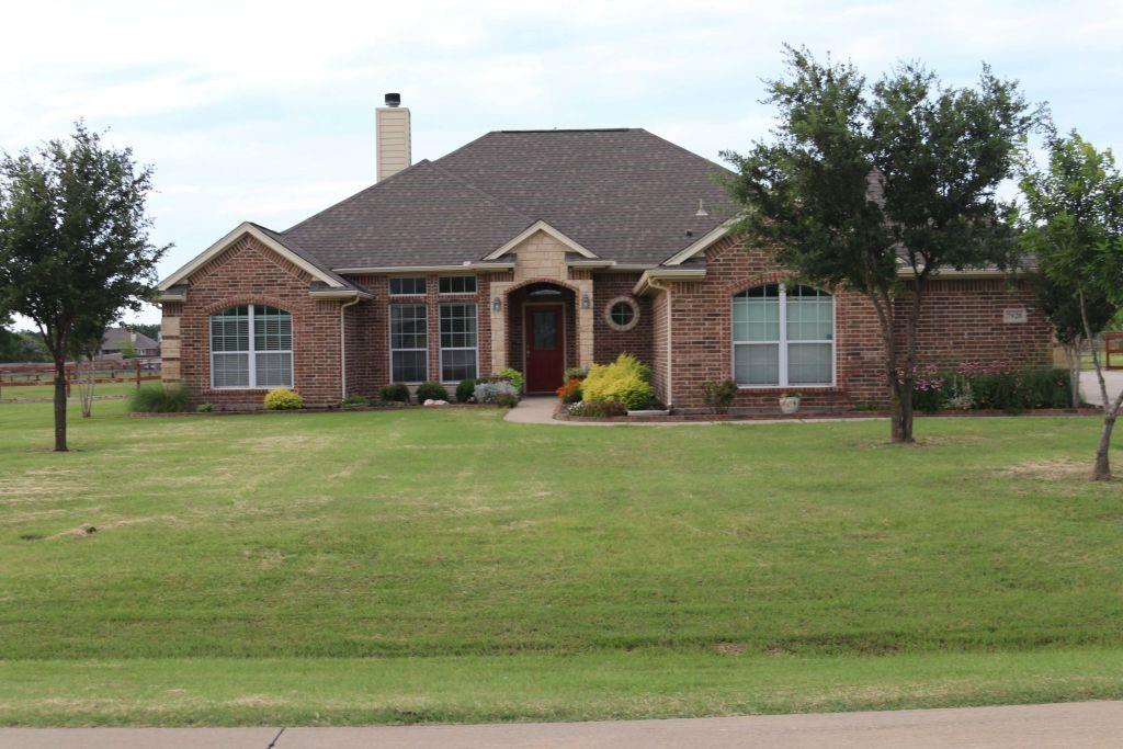 a front view of house with yard and green space