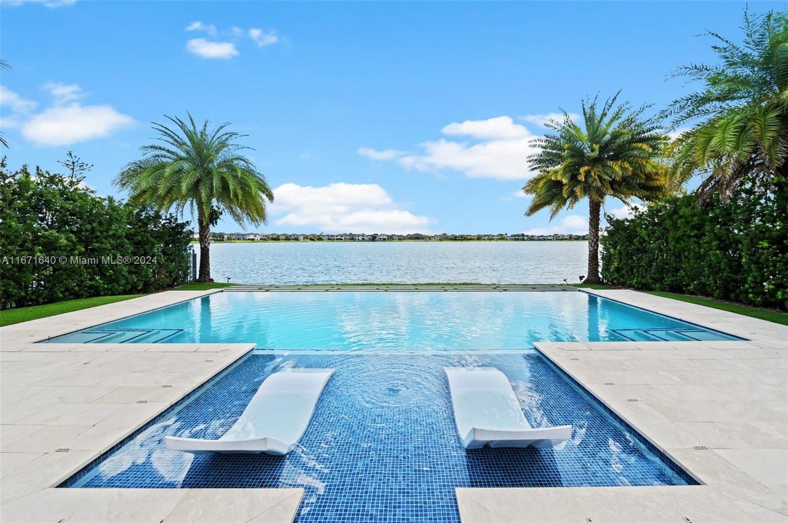 a view of a swimming pool with a chair and large trees